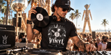 DJ wearing Grooveman Vinyl graphic T-shirt at a turntable in Miami Beach