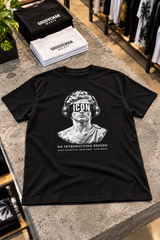 Black ICON graphic T-shirt displayed on a concrete table beside folded Grooveman tees, featuring a marble statue wearing headphones.