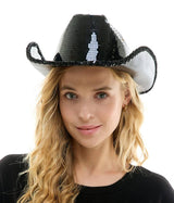 Woman wearing a black and white sequin cowboy hat on a white background