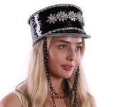 Woman wearing a black sequin hat with decorative elements on a white background