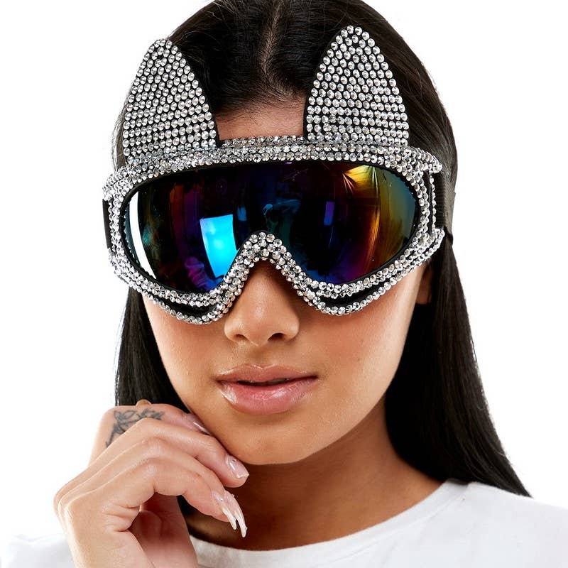 Person wearing sparkling goggles with a white background