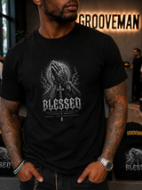 A man wearing a black crewneck t-shirt with a detailed grayscale graphic of praying hands and the word 'BLESSED' on the front, set in a gym environment with a Grooveman sign in the background.