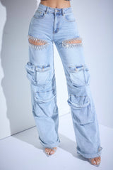 Light blue jeans with embellishments on a white background