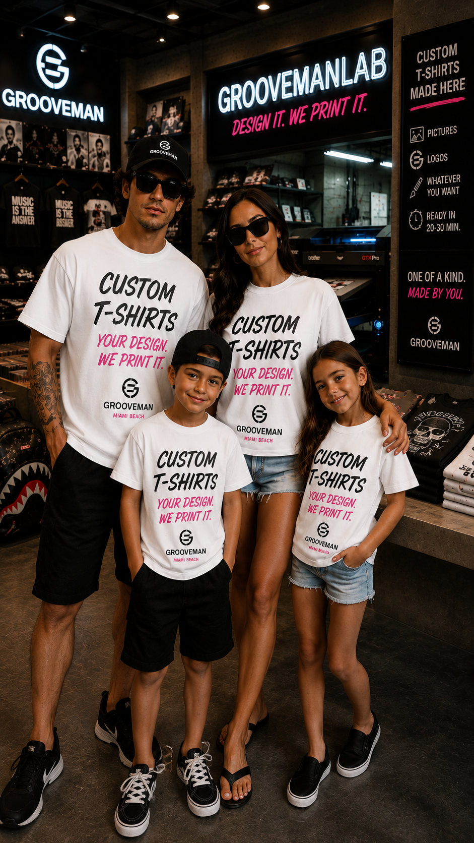 A family of four posing together inside a Groovemanlab retail store, wearing matching white custom graphic t-shirts with black and pink text.