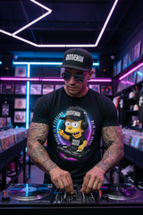 Black t-shirt with a cartoon character DJing on a hanger against a dark background