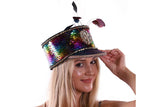 Woman wearing a colorful sequin hat with feathers on a white background