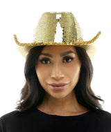 Woman wearing a gold sequin cowboy hat on a white background