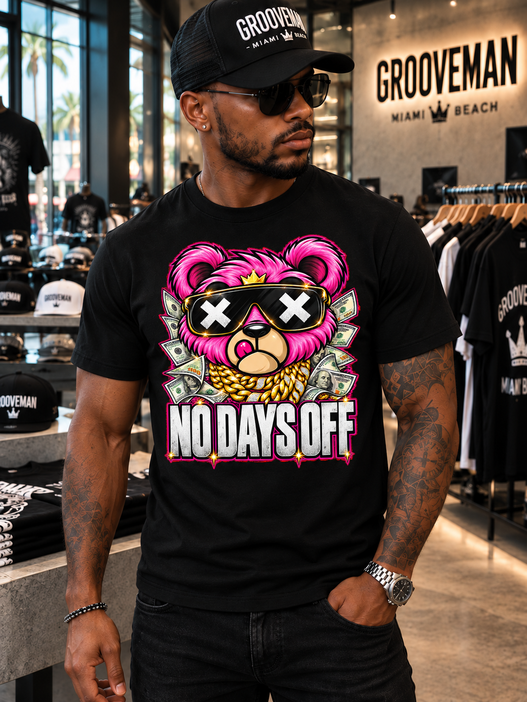 Front view of the black No Days Off T-shirt with a hot pink teddy, X-mark sunglasses, gold crown and money graphics.