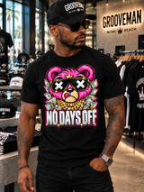 Front view of the black No Days Off T-shirt with a hot pink teddy, X-mark sunglasses, gold crown and money graphics.
