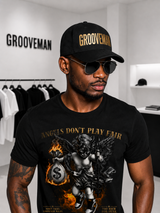 Man wearing a black 'Grooveman' cap and black t-shirt with graphic design in a store setting.