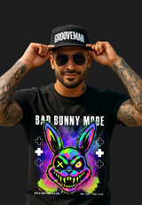 Man wearing a black t-shirt with a colorful graphic and 'Bad Bunny Made' text, standing outdoors with palm trees in the background.