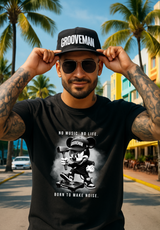 Man wearing a black t-shirt with 'Grooveman' design and a cap, standing outdoors with palm trees in the background.