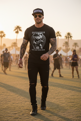 Black t-shirt with teddy bear graphic and text on a wooden hanger against a dark background