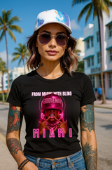 Woman wearing a black t-shirt with 'Miami' design, sunglasses, and cap in a tropical setting.