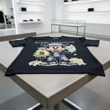 Black t-shirt with a graphic design of a character holding money on a light gray background