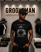 Man wearing a black t-shirt with a graphic design in a store with 'Grooveman' branding.