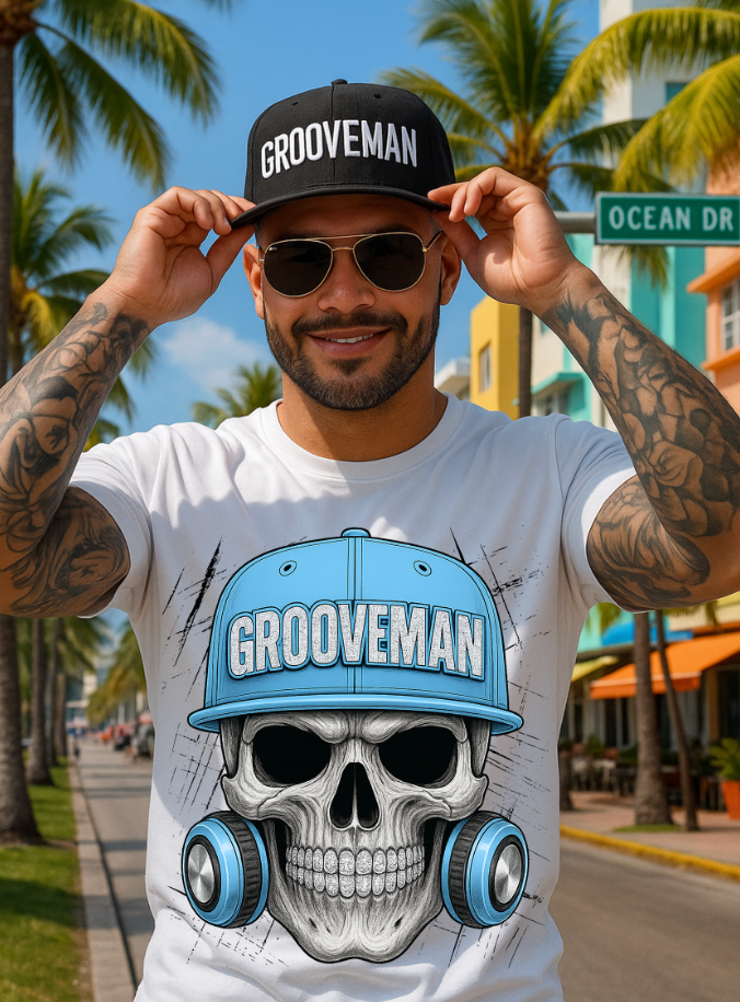 Man wearing a white t-shirt with a skull design and 'Grooveman' text, standing on a street with palm trees.