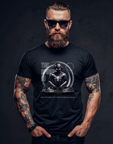 Man wearing a black t-shirt with a spider design and text on a dark background