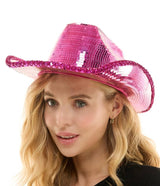 Woman wearing a pink sequin cowboy hat on a white background