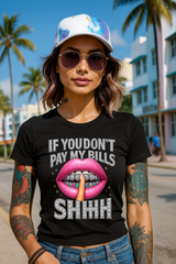 Woman wearing a black t-shirt with a graphic design and text, standing on a street with palm trees in the background.