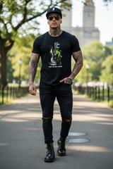 Black t-shirt with a graphic design on a hanger against a dark background