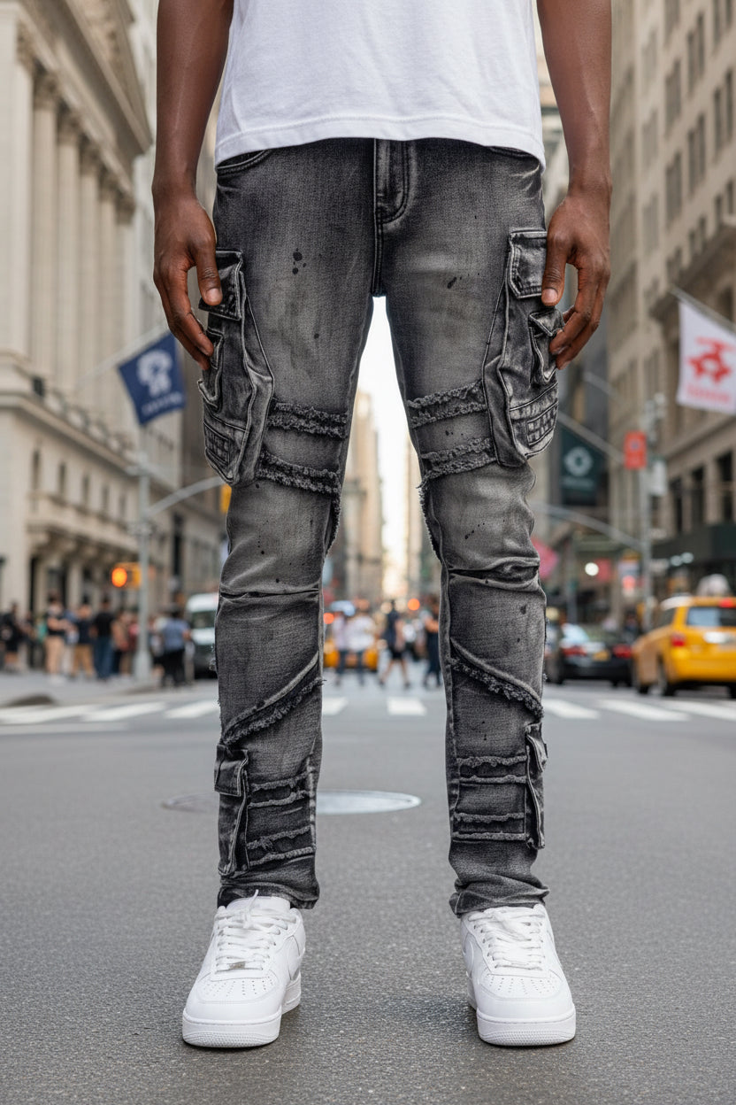 Person wearing gray distressed jeans on a white background