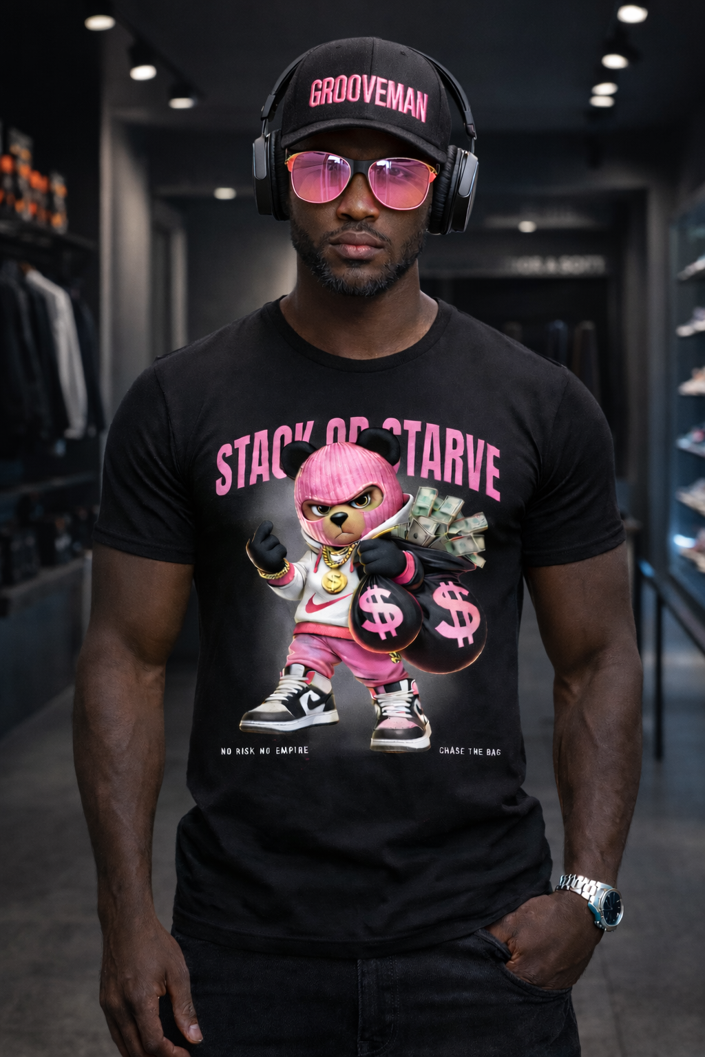Man wearing a black t-shirt with a graphic design, pink sunglasses, and a cap in a store setting.