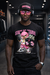 Man wearing a black t-shirt with a graphic design, pink sunglasses, and a cap in a store setting.