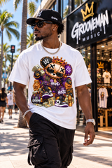 A man wearing a white graphic t-shirt with a cartoon bear design, black cargo pants, and a black cap, walking on a sunny street in front of a Groovemusic store.