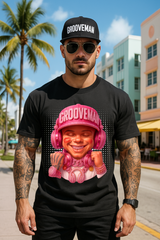 Man wearing a black t-shirt with a graphic design of a person in a pink outfit and helmet, standing on a street with palm trees and buildings in the background.