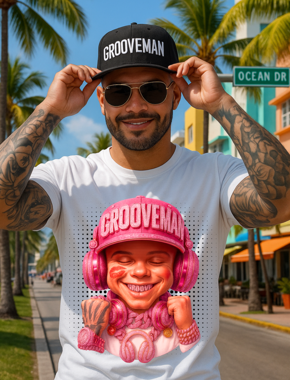 Man wearing a t-shirt with a 'GrooveMan' graphic on a street with palm trees and a sign in the background.