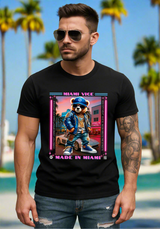 Man wearing a black t-shirt with a graphic design of a bear in a blue jacket and cap, standing against a plain background.