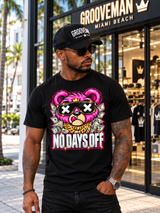 Model wearing the black No Days Off pink teddy bear T-shirt and Grooveman cap outside the storefront.