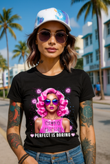 Woman wearing a black t-shirt with a graphic design and sunglasses, standing on a street with palm trees in the background.