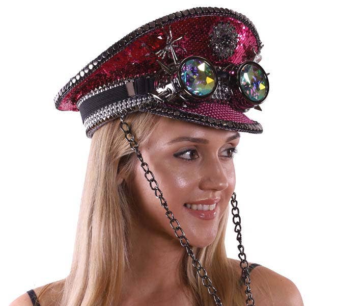 Person wearing a decorative hat with gemstones and chains on a white background