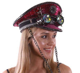Person wearing a decorative hat with gemstones and chains on a white background