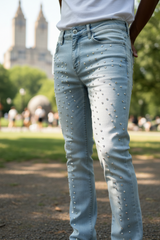 Light blue jeans with rhinestone embellishments worn by a person in an outdoor setting.
