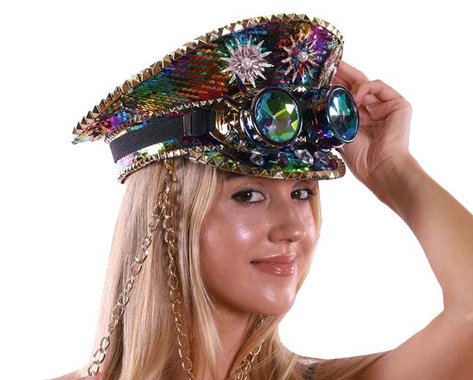 Person wearing a colorful, ornate hat with gemstones and chains on a white background