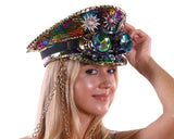 Person wearing a colorful, ornate hat with gemstones and chains on a white background