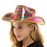 Woman wearing a colorful sequin cowboy hat on a white background