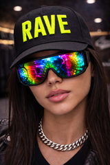 Person wearing a black cap with 'RAVE' in yellow and colorful reflective sunglasses.