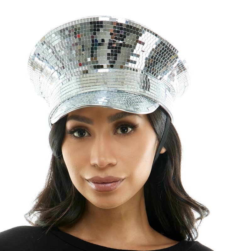Person wearing a silver disco hat on a white background