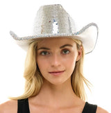 Person wearing a silver sequin cowboy hat on a white background