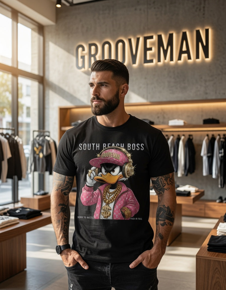 Man wearing a black t-shirt with a graphic design in a clothing store named 'Grooveman'.