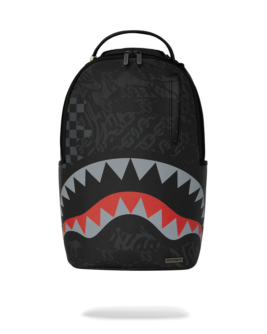 A black Sprayground Shark backpack with a stylized shark mouth graphic in red, gray, and white on the lower front, shown against a plain white background.