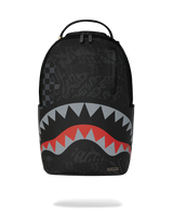 A black Sprayground Shark backpack with a stylized shark mouth graphic in red, gray, and white on the lower front, shown against a plain white background.