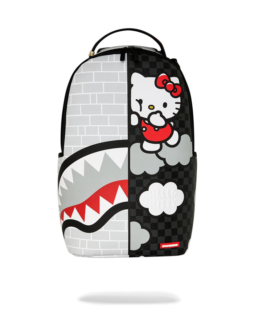 A Sprayground x Hello Kitty backpack featuring a split design: one half shows a white brick wall pattern with a shark mouth graphic, and the other half shows Hello Kitty on a black checkered background with clouds.