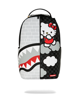 A Sprayground x Hello Kitty backpack featuring a split design: one half shows a white brick wall pattern with a shark mouth graphic, and the other half shows Hello Kitty on a black checkered background with clouds.