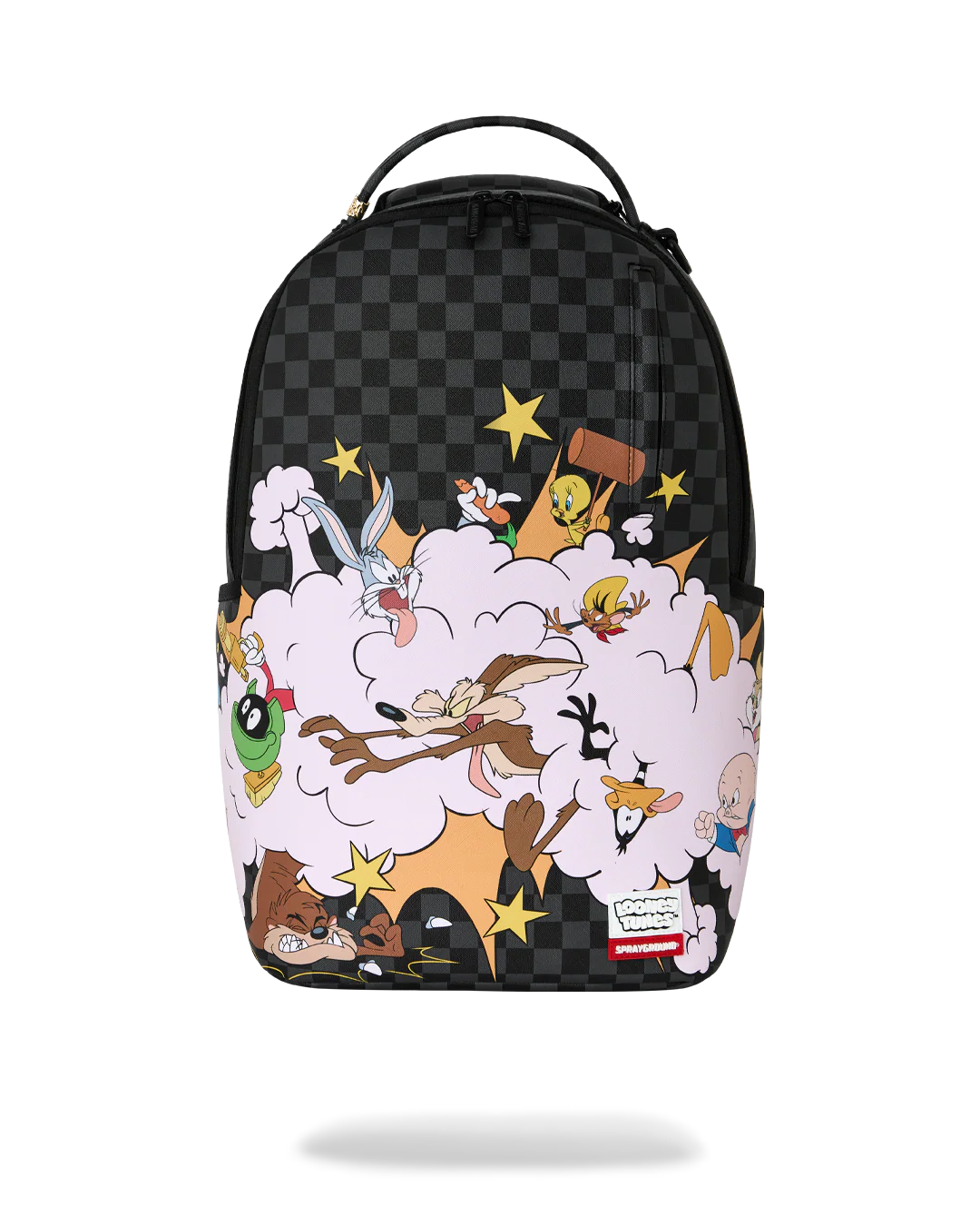 A Sprayground backpack featuring a black and gray checkerboard pattern on the upper half and a colorful cartoon explosion graphic on the lower half, with a top handle and Sprayground logo patch.