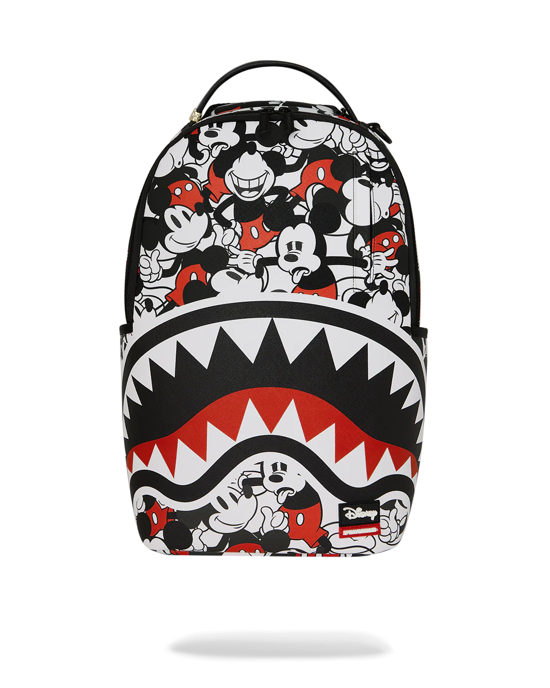 Backpack with cartoon character design and shark mouth graphic on a white background